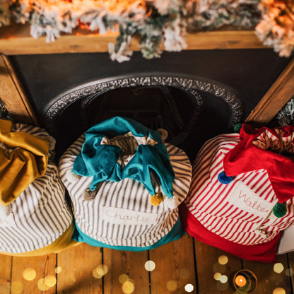 Personalised Christmas sacks with pom pom details and embroidered personalised tag.