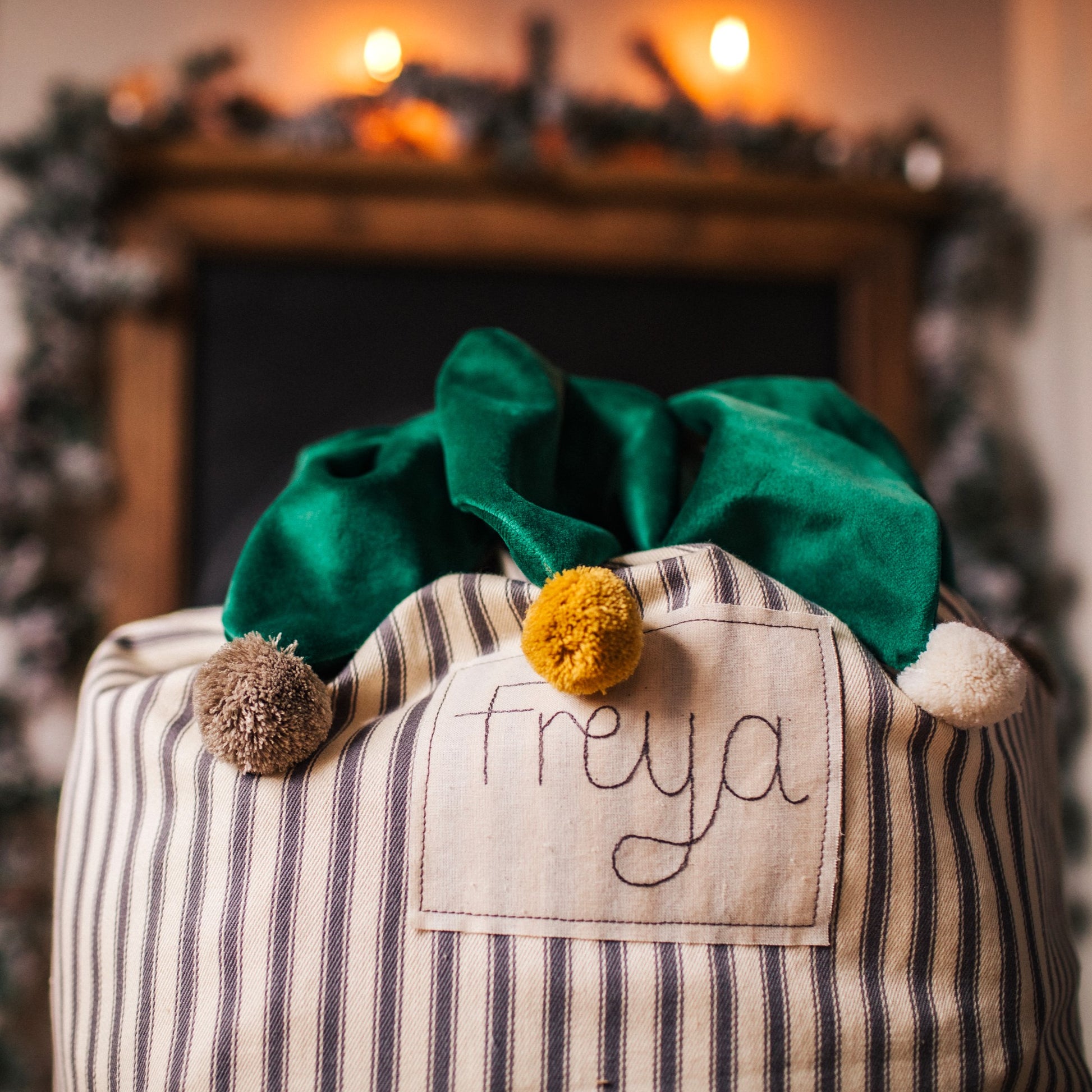 Personalised Christmas sack with pom pom details and embroidered personalised tag.