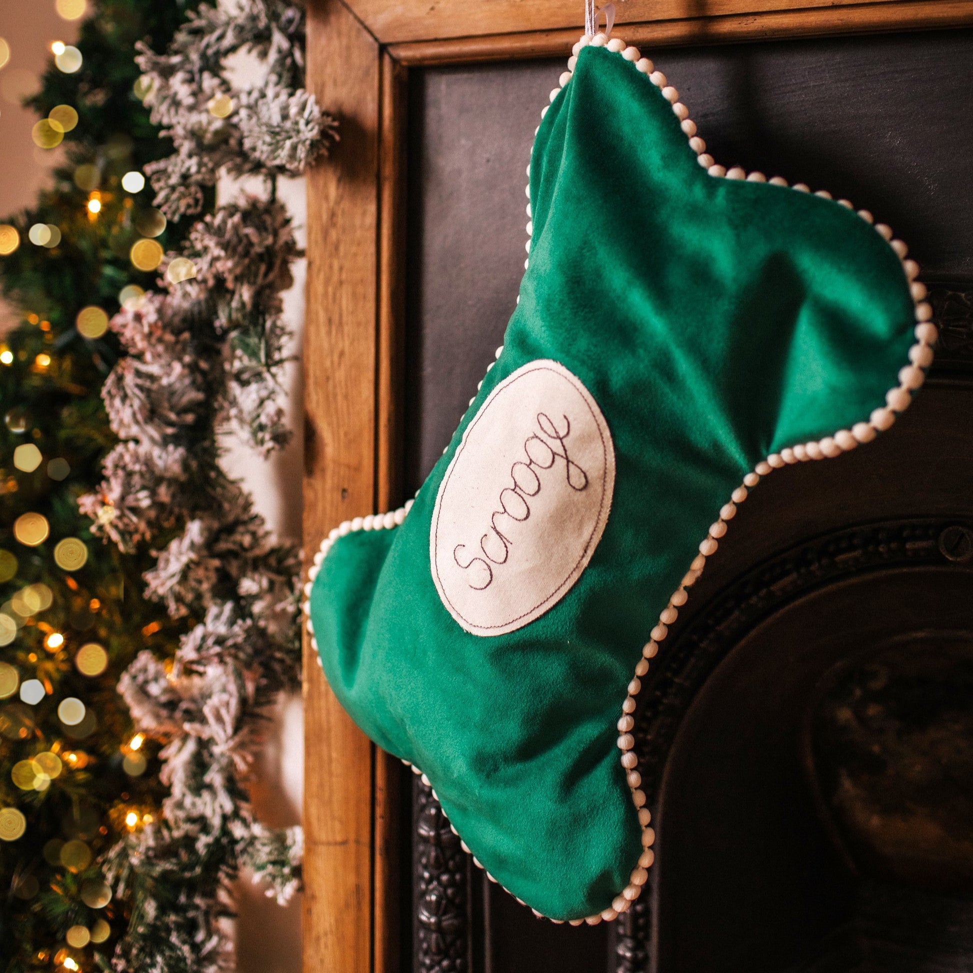 Velvet dog bone shaped personalised stocking. Lined in cotton with a pom pom trim.