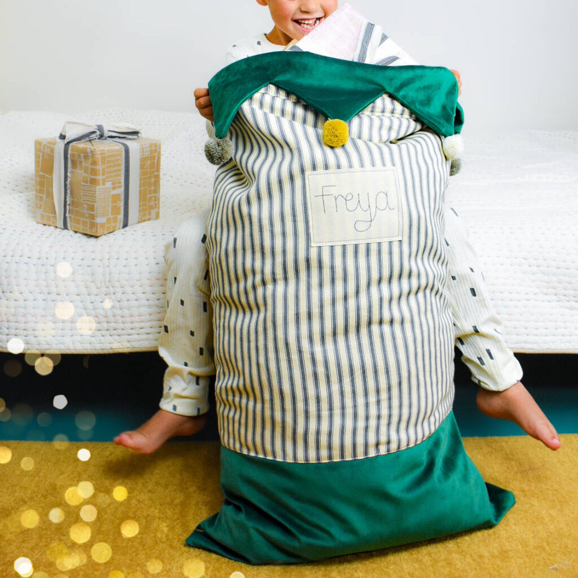 Personalised Christmas sacks with pom pom details and embroidered personalised tag.