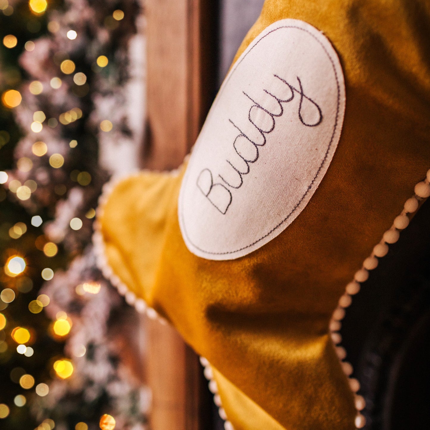 Velvet dog bone shaped personalised stocking. Lined in cotton with a pom pom trim.
