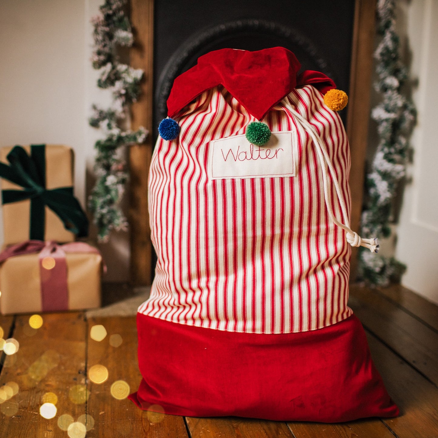 Personalised Christmas sack with pom pom details and embroidered personalised tag.