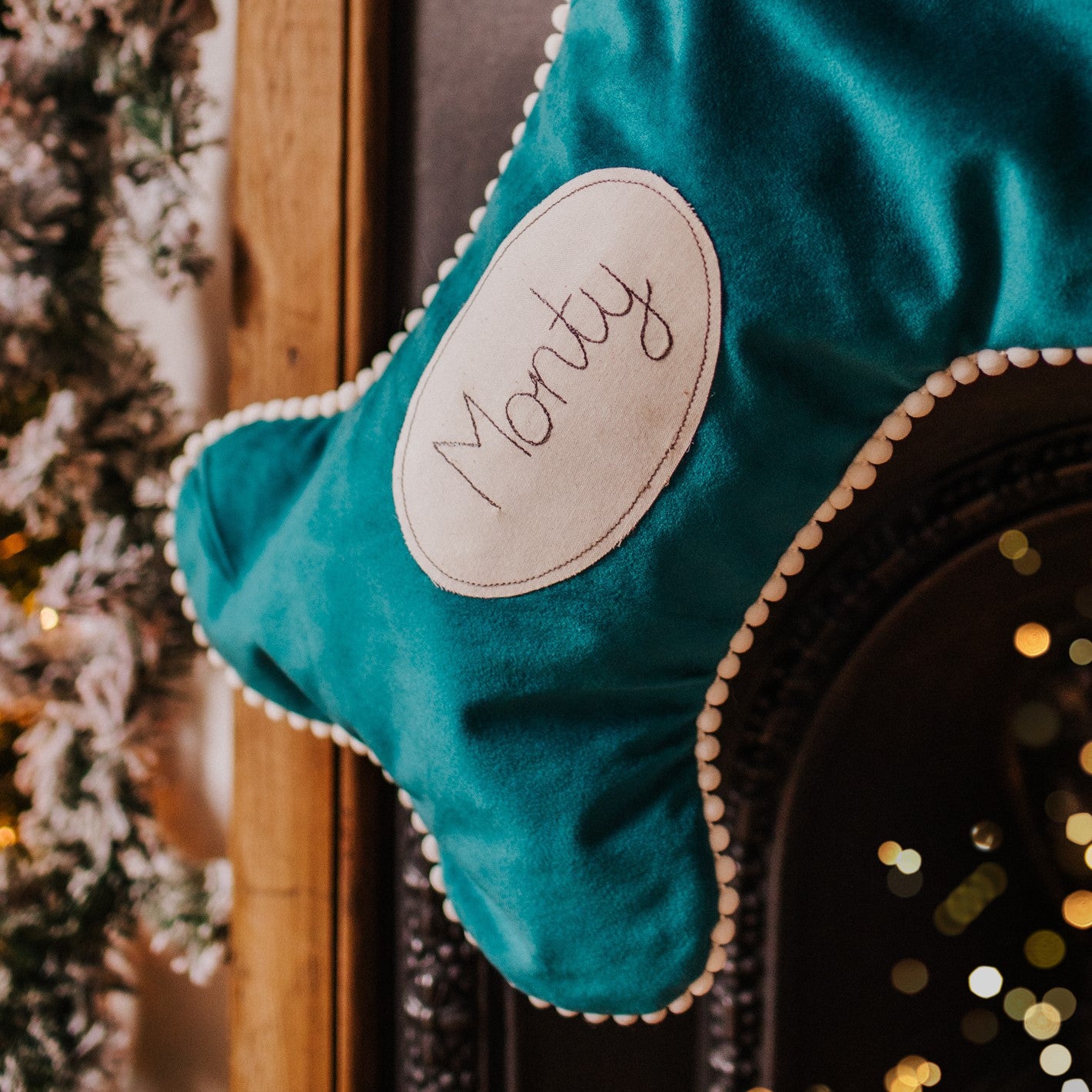 Velvet dog bone shaped personalised stocking. Lined in cotton with a pom pom trim.