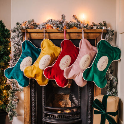 Velvet dog bone shaped personalised stocking. Lined in cotton with a pom pom trim.