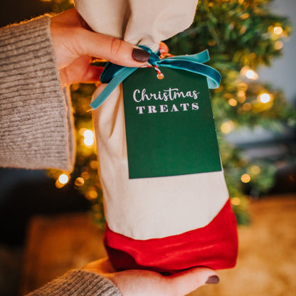 A reusable cotton and velvet gift bag with gift tag