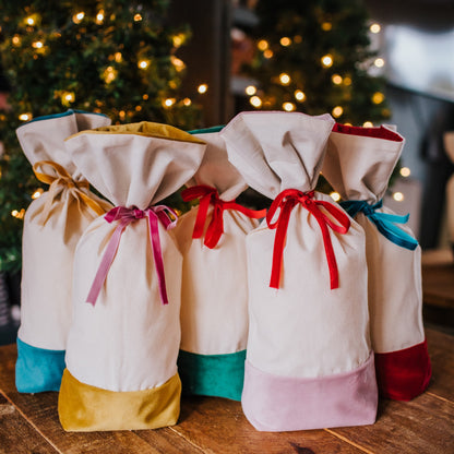 A reusable cotton and velvet gift bag with gift tag