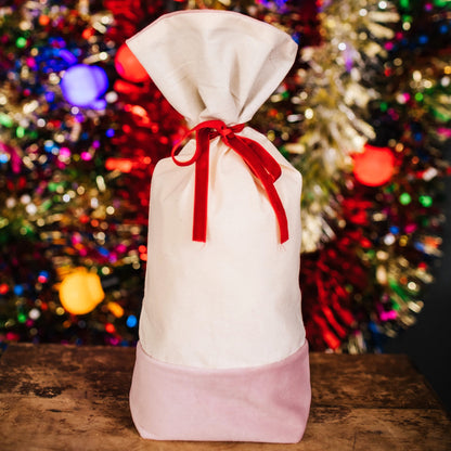 A reusable cotton and velvet gift bag with gift tag