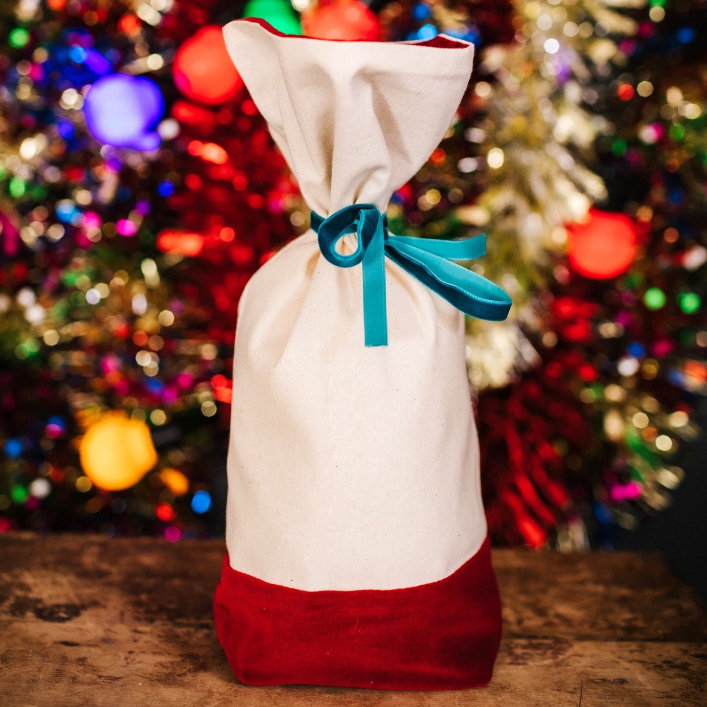 A reusable cotton and velvet gift bag with gift tag