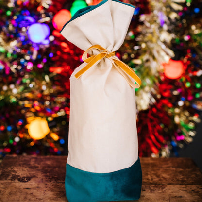 A reusable cotton and velvet gift bag with gift tag