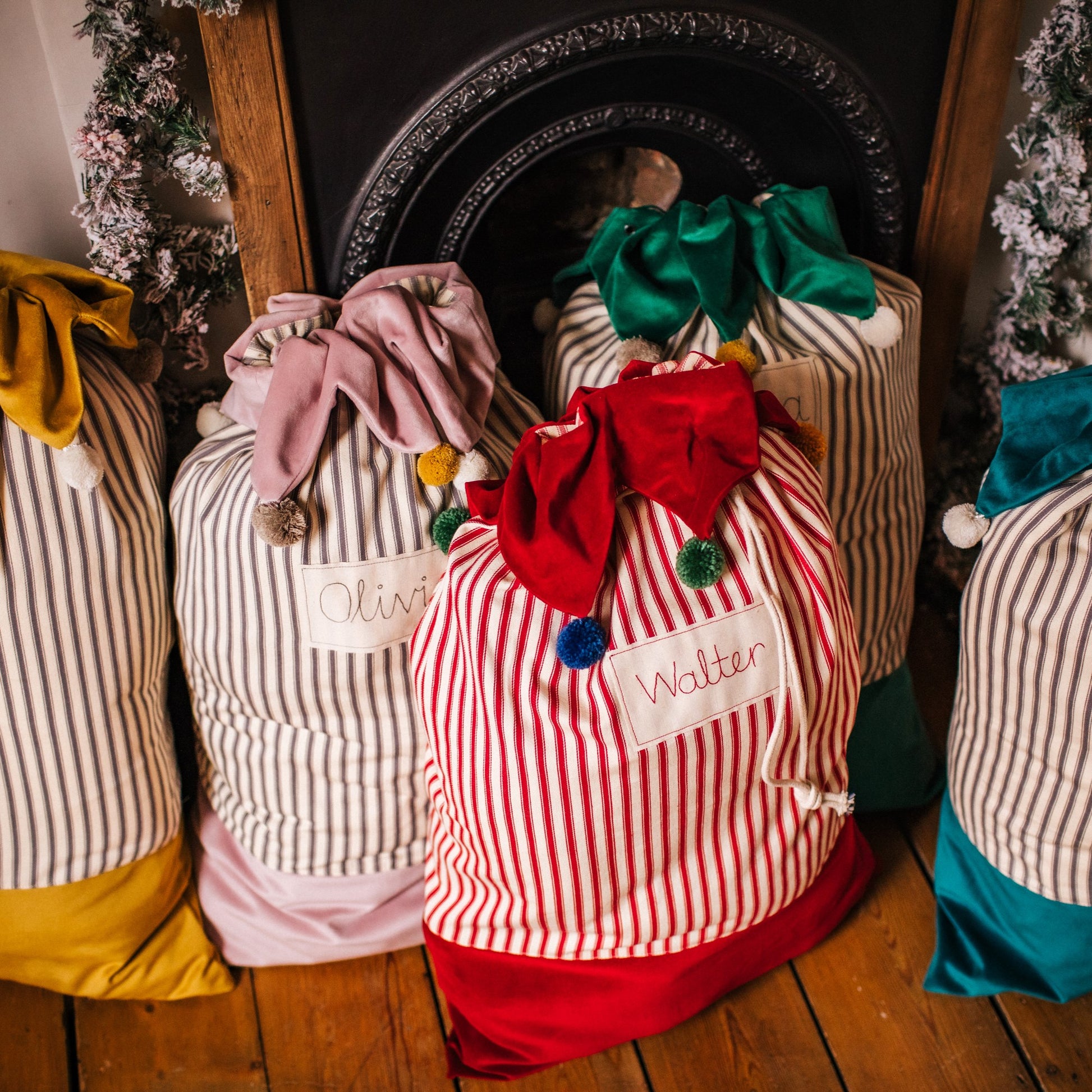 Personalised Christmas sacks with pom pom details and embroidered personalised tag.