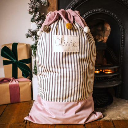 Personalised Christmas sack with pom pom details and embroidered personalised tag.