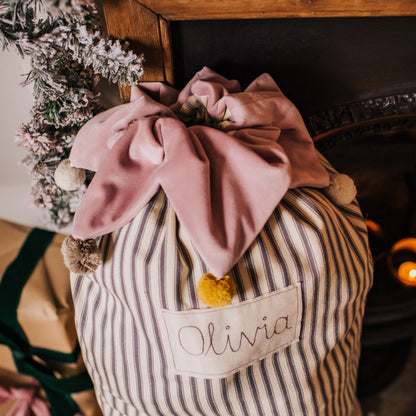 Personalised Christmas sack with pom pom details and embroidered personalised tag.